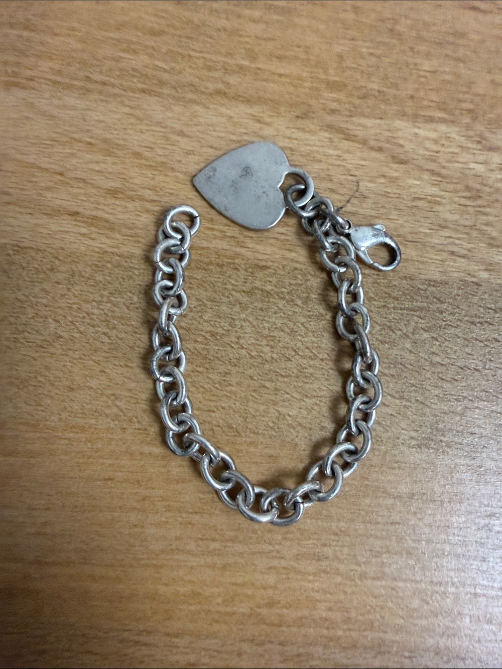 Silver tone chain link bracelet with heart charm